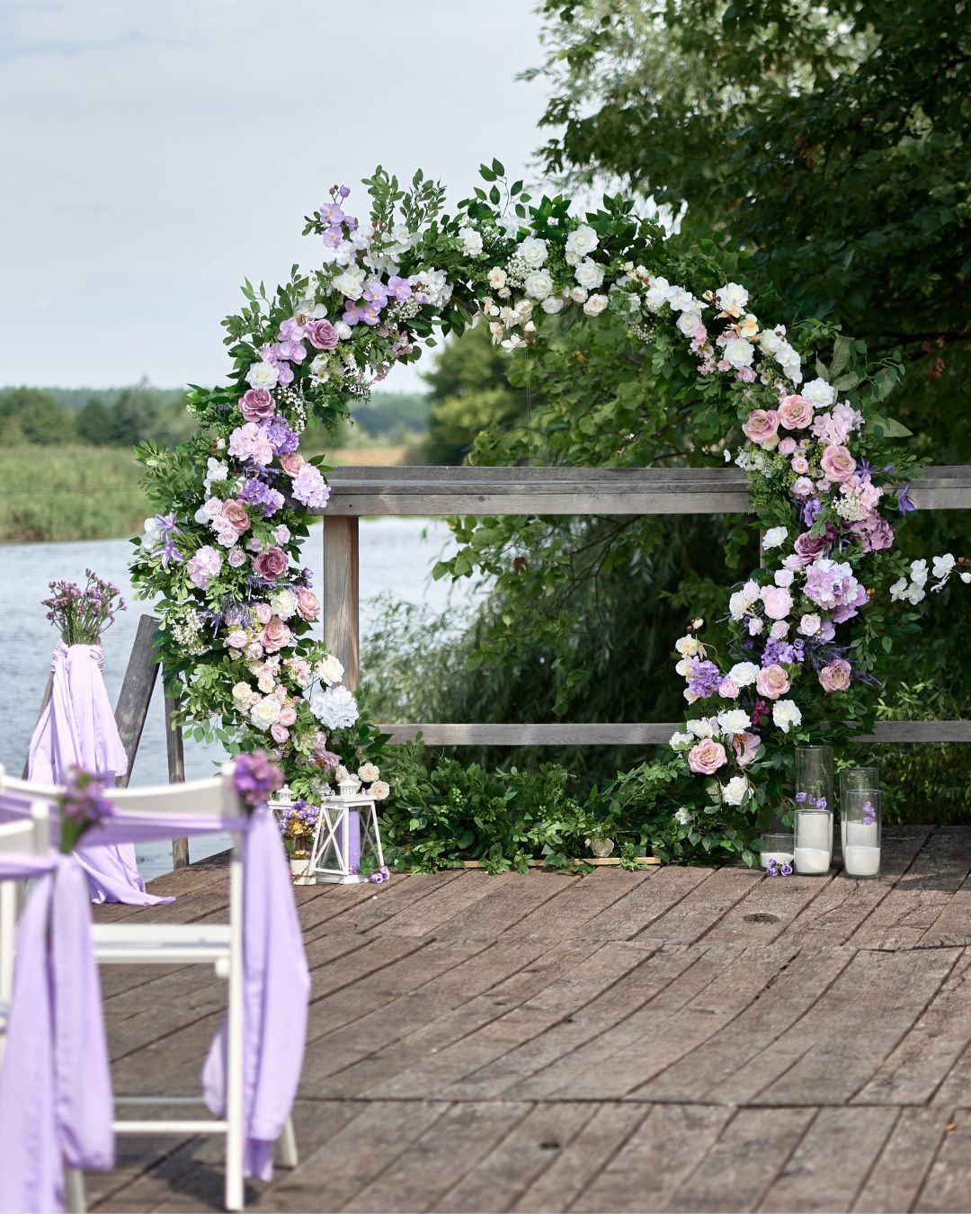Romantic Purple Floral Arch Idea for A Spring Wedding Create a dreamy light purple spring outdoor wedding decor with lilac floral arches and lush greenery – all available at ShopWildThings.com