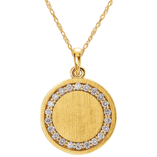 Round diamond halo disc initial pendant in 14k yellow gold.