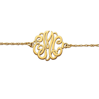 Monogram bracelet with hand cut out script letter details in 14K yellow gold.