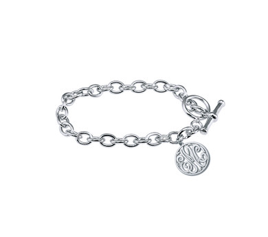 Script monogram cut out letters round charm toggle bracelet in sterling silver.