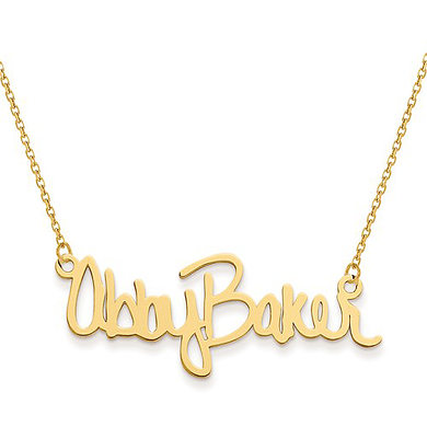 Signature cursive full name plate necklace in 14K yellow gold.