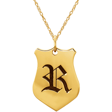 Shield shaped enamel initial pendant in 14k yellow gold.