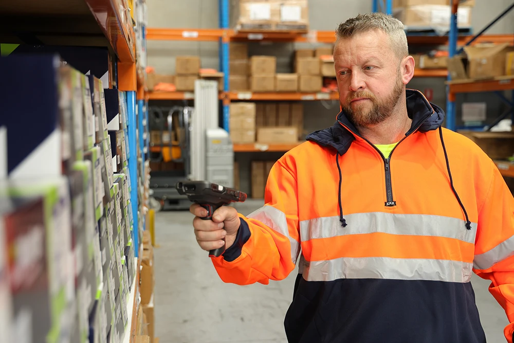 Safeman team member using a barcode reader in the warehouse