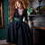 Woman Posing with hands fully in pockets spreading out the Forager Skirt in black, paired with the Artemis Crop Kimono.