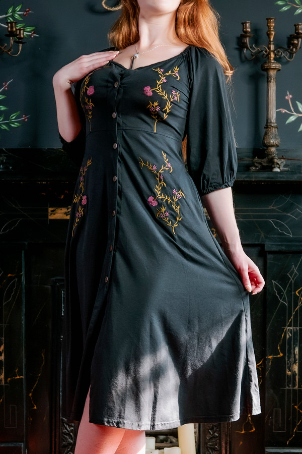 Model posing in black Persephone Summer Dress