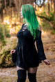 Occultist Dress, a witchy style long sleeve mini dress with lace accents, open shoulders, and a lace up chest, front side view