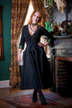 Woman posing in studio with one hand on hip wearing the Forager Skirt in black paired with the Artemis Crop Kimono.