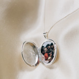 family photograph inside large oval pendant picture locket made of sterling silver