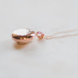 medium size round locket made of rose gold that can hold two pictures