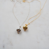 The Gold Edith Locket and The Silver Edith Lockets side by side, both modern petite keepsakes