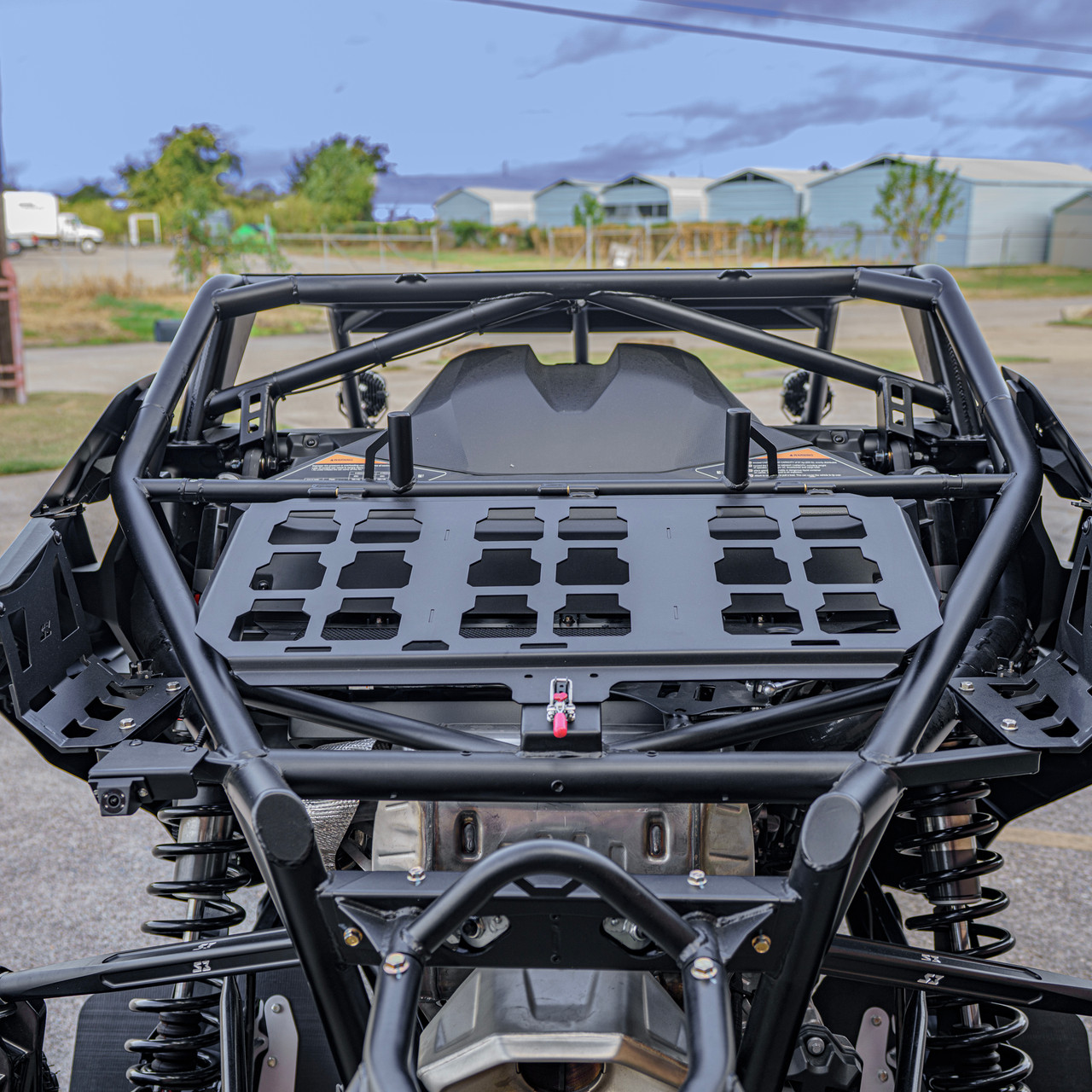 2026 Can-Am Maverick R, Green / Black, close-up rear view showing the cargo rack, roll cage, and rear suspension