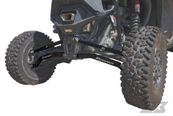 Polaris RZR Turbo R Billet Aluminum High Clearance Radius Rods, black branded radius rods installed on the rear suspension between the rugged off-road tires. - S3 Power Sports