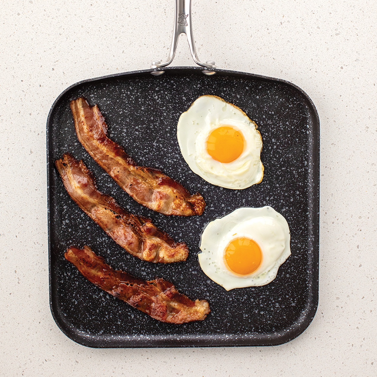 https://cdn11.bigcommerce.com/s-x58in4vio5/images/stencil/1280x1280/products/785/3628/21171_11inch_Square_Griddle_with_breakfast_foods_overhead_1K__39993.1693590738.jpg?c=1