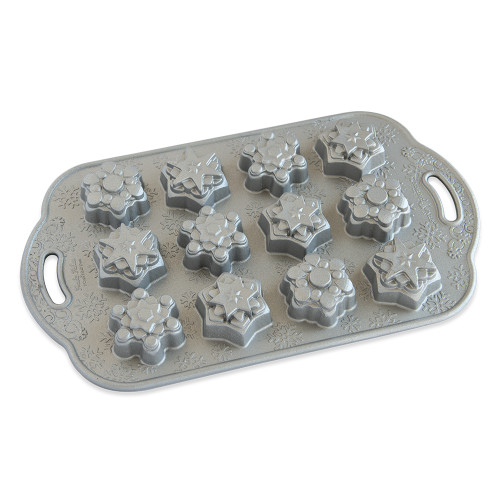 Nordic Ware aluminum baking pan with 12 snowflake-shaped cavities, natural silver finish