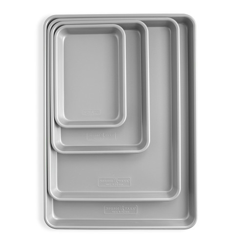 Nordic Ware 4-piece nonstick bakeware set with two sheet pans and cooling racks, dark coating, overhead view
