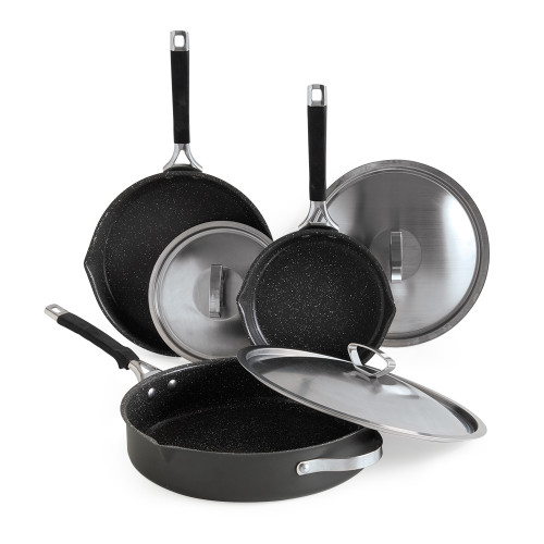 Nordic Ware Verde ceramic nonstick skillet set with three green pans and matching glass lids on white background