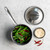 overhead of basalt 1.5qt saucepan filled with string beans placed on countertop with lid and dish of seasoning next to it
