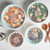 overhead of Nordic Ware 8 piece seaglass and white 7 quart, 5 quart, 3.5 quart and 2 quart bowls filled with salad, potatoes, mixed nuts and rolls