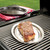 cut of steak on nordic ware sizzling steak server plate cooked on grill