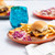 outdoor table scene of plated square patty slider with fries and veggies