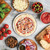unbaked pizza with ingredients on hot air pizza crisper