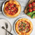 freshly baked pizzas on hot air pizza crisper pans