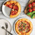 freshly baked pizzas on hot air pizza crisper pans