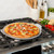 nordic ware aluminized steel pizza & baking steel pan on stovetop with pizza