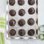 Chocolate cookies arranged on Nordic Ware Naturals aluminum half sheet pan with vintage starburst textured bottom