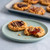 Nordic Ware aluminum half sheet pan with golden-brown peanut butter and jelly cookies arranged on surface