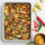 Nordic Ware Brilliant quarter sheet pan with roasted diced potatoes, bell peppers, and melted cheese