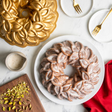 Glazed Laurel Wreath Bundt on white plate, pistachios on cutting board