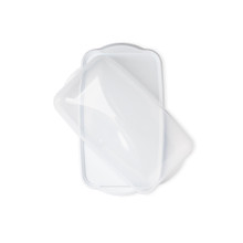 rectangular loaf cake keeper in white color with clear lid, plastic storage container, lid partially off, overhead