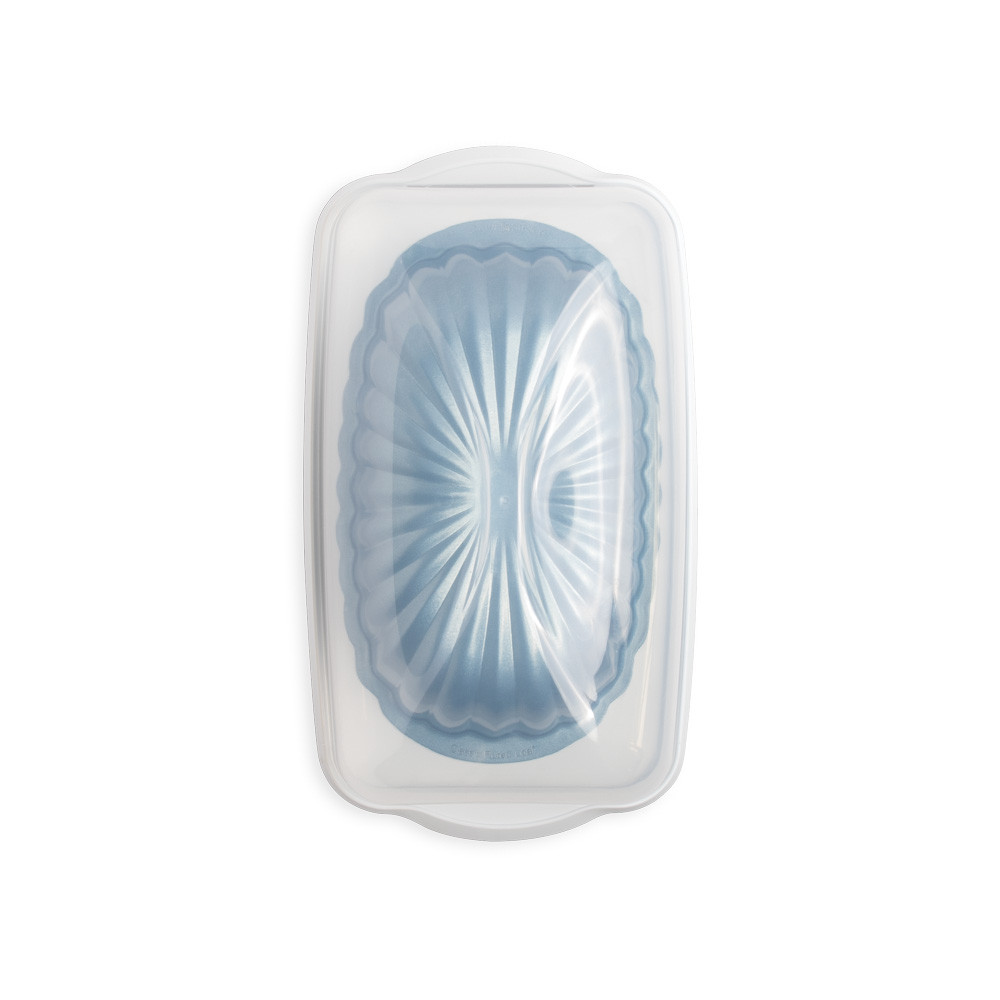 fluted loaf pan in loaf keeper with lid closed on white background
