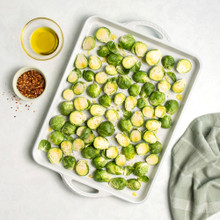 overhead view of cardamom large baking sheet with unbaked brussel sprouts