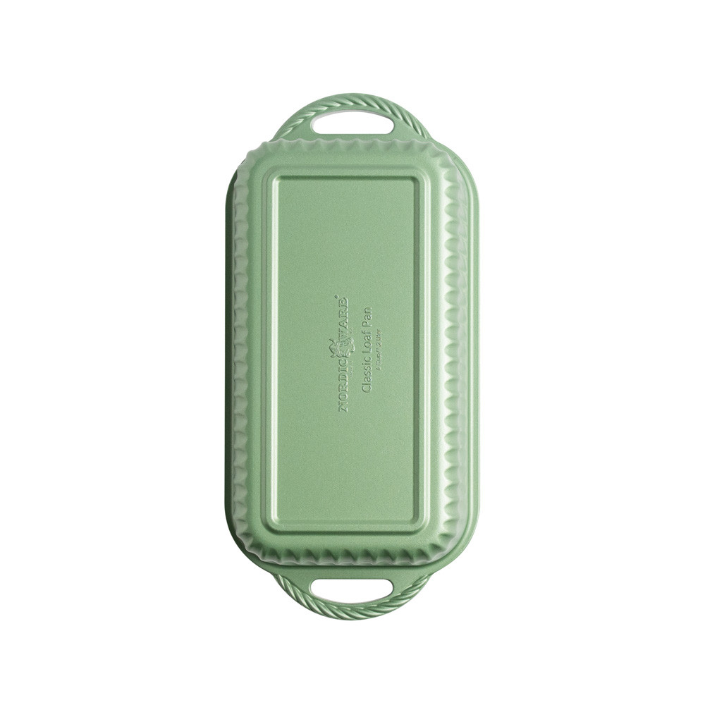 overhead view of cardamom loaf pan on white background showing green exterior