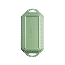 overhead view of cardamom loaf pan on white background showing green exterior