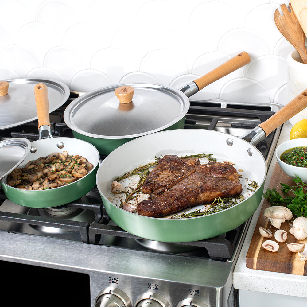 cardamom saute pans and lids on stovetop with food