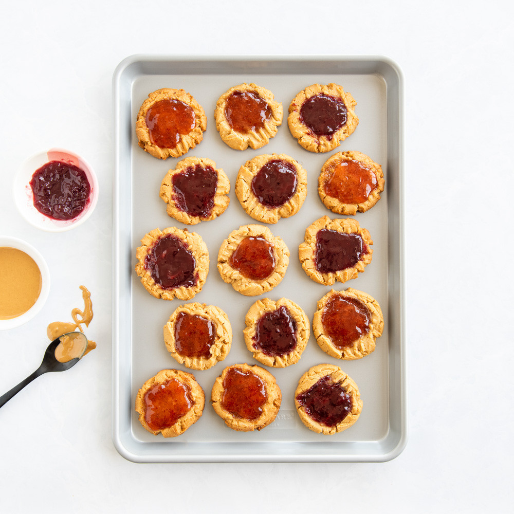 overhead image of brilliant half sheet with pb&j cookies