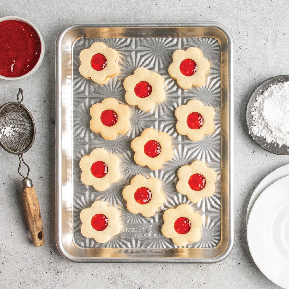 overhead of jam-filled novelty shaped cookies on starburst quarter sheet pan