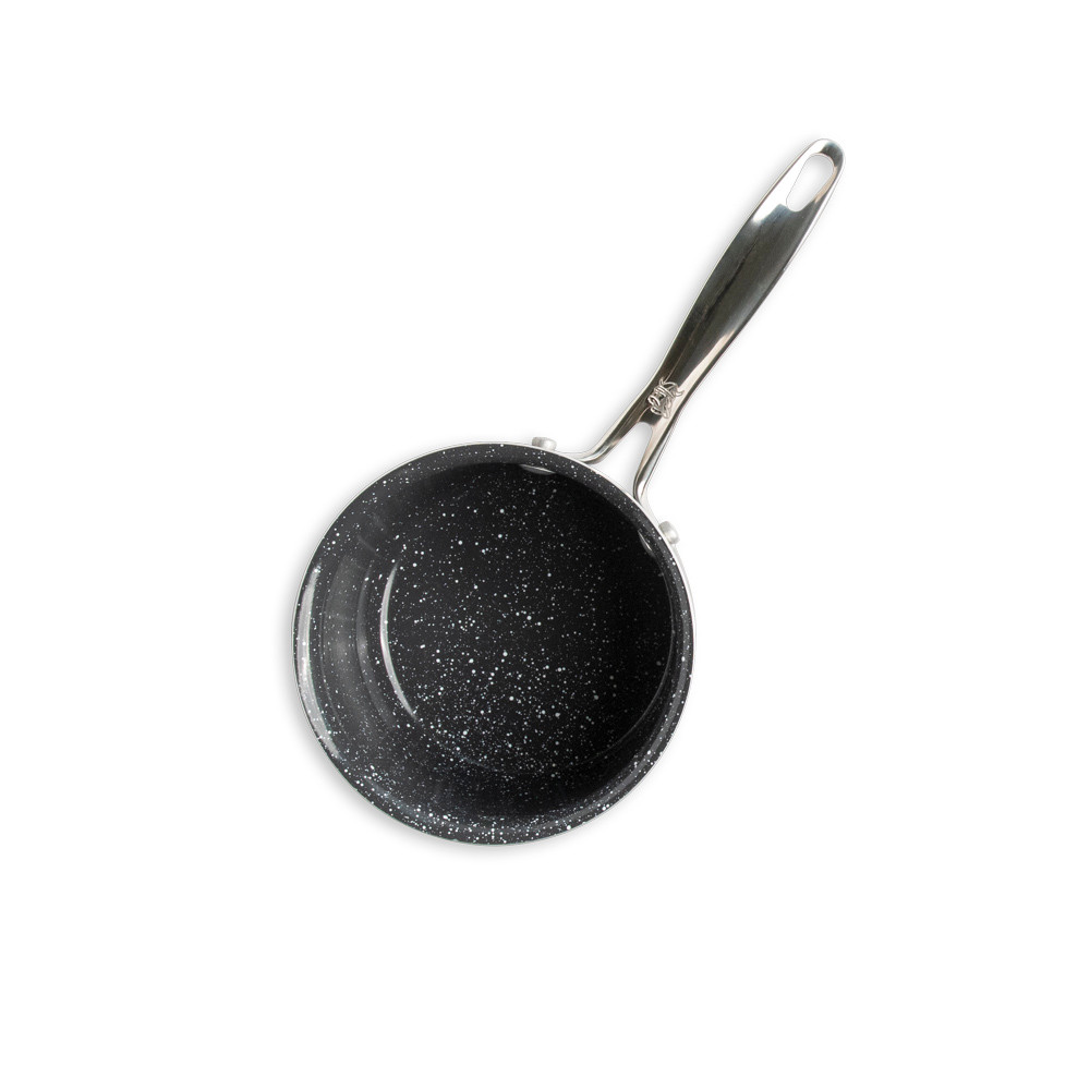 overhead of basalt 1.5qt saucepan showing speckled ceramic interior coating on white background