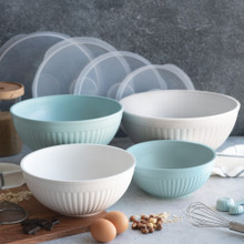 8 piece covered bowl set staged on countertop with various ingredients and baking utensils