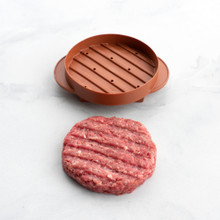 ribbed side of round stuffed burger press part staged with shaped hamburger meat with pressed lines