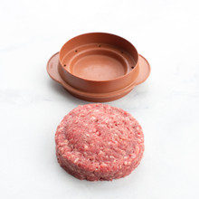 round stuffed burger press part staged with shaped hamburger meat