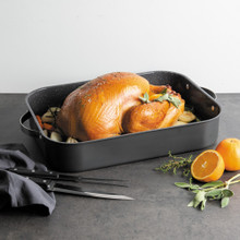 cooked turkey and veggies staged inside Nordic Ware Verde Grand Roaster with speckled nonstick interior and stainless steel handles