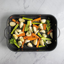 veggies prepped inside Nordic Ware Verde Grand Roaster with speckled nonstick interior and stainless steel handles