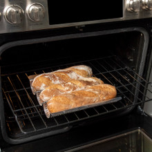 Nordic Ware baguette & french bread pan staged in open oven with fresh baked baguettes