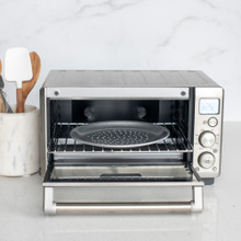 nordic ware compact perforated hot air pizza crisper staged in toaster oven