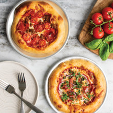 freshly baked pizzas on hot air pizza crisper pans