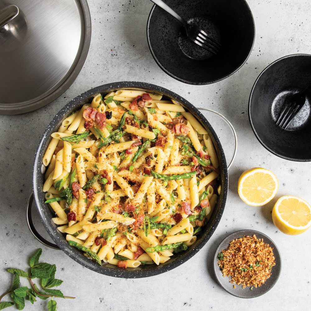 nordic ware 6 qt aluminum dutch oven with pasta with lid in the background